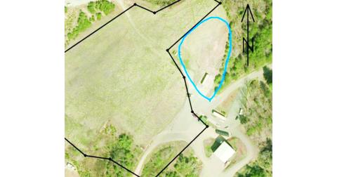 The blue circled area in this aerial photo shows a possible site for a new recycling and household garbage center near the Transfer Station. The dark line represents the boundary of the capped landfill area.