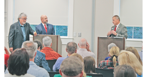 Incumbent Sheriff Stacy Jarrard (right) addresses challenger Matt Cook during last week’s candidate forum as moderator Roger Smith (far left) glances at his notes.