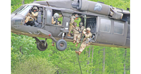 A fire team of Rangers from the U.S. Army’s 5th Ranger Training Battalion demonstrate a “fast rope” insertion from a UH-60 Black Hawk helicopter at Camp Frank D. Merrill on Saturday.