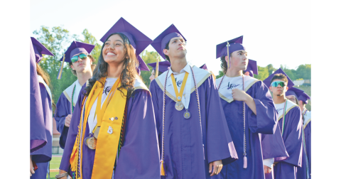 Pictured (from left) Salutatorian Zoha Munshi, Alejandro Narvaez and Duke Nelson react to the cheers of the crowd as the seniors enter the commencement ceremony.