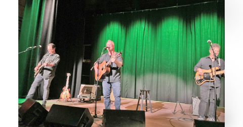 Shawn Mullins (center) is pictured along with band mates Patrick Blanchard on electric guitar and Tom "Panda" Ryan on bass on the stage of The Holly Theater.