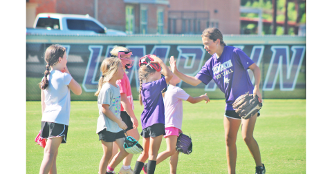 Lumpkin County player Addilaide Antonia works with the younger athletes during the softball youth summer camp.