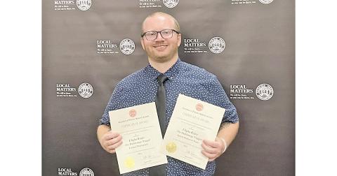 Nugget sportswriter Eligha Roper shows off new awards after the Georgia Press Association ceremony.