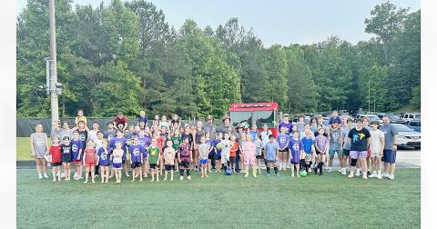Lumpkin County soccer campers gather for a group photo after a fun drenching by the Lumpkin fire department.