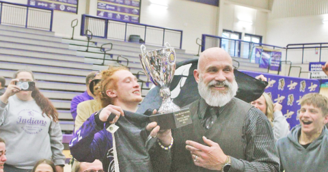 Lumpkin Wrestling Head Coach Sean Hage hoists the team’s Dual State Championship trophy at the conclusion of last year’s wrestling season.