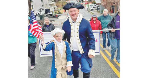 Jim Guy and his son Beau march their way towards the square in the Veterans Day parade. This July 4, Jim will return to the Public Square, in colonial attire, to read the Declaration of Independence.