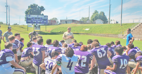 Head Coach Brenton Ruark closes out practice surrounded by his middle school team.