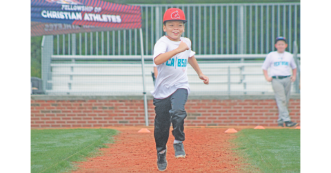 Blake Huff sprints to first during the FCA baseball summer camp at Lumpkin County High School.