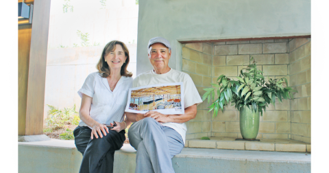 Doghobble Wine Farm owners Sam Zamarripa and his wife Robin proudly display plans for the 1972 farmhouse that will become their new indoor tasting room. The winery’s namesake mountain doghobble plant can be seen in the vase to their right.
