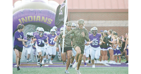 The Lumpkin County High School football team races onto the field ahead of their game against Hart County.