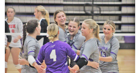 The LCHS volleyball team celebrates its victory over Rabun after winning the third set.