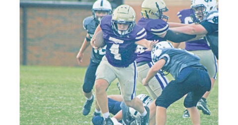 Lumpkin County’s Ben Monroe stiff-arms his way through White County defenders.