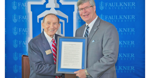 Faulkner University President Mitch Henry, right, presents local philanthropist Bud Stumbaugh with a plague commemorating the recent establishment of The Stumbaugh School of Risk Management & Insurance.
