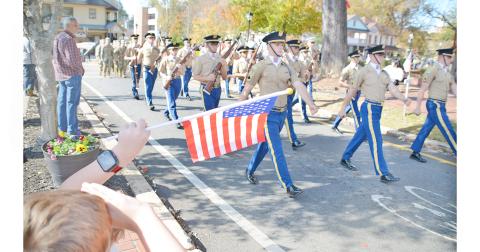 Local residents salute the Blue Ridge Rifles and the cadets from the University of North Georgia during last week’s Veterans Day parade in Dahlonega. (Photo by John Bynum)