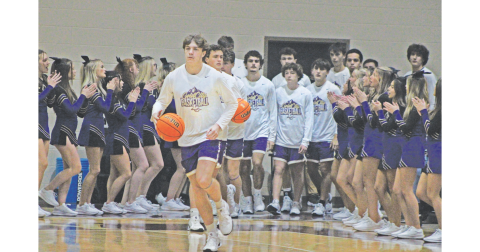 TJ Gaddis brings the team onto the court against Dawson. Gaddis led the Indians in scoring with 24 points against the Tigers.