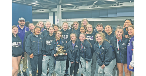 The Lumpkin County girls wrestling squad gathers following their first place performance in Alabama.