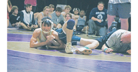 Lumpkin County High School wrestler Geovany Hernandez smiles as he pins his White County opponent.