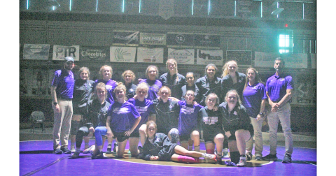 The Lumpkin County girls wrestling team celebrates their victory after their meet against Burke County.