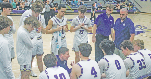 Lumpkin County boys basketball head coach Chris Faulkner talks strategy with his team during a recent home game.