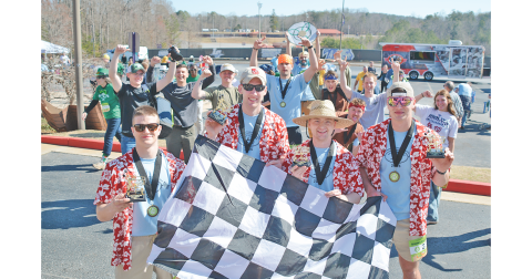 After the dust settled in the final round of the Grocery Grand Prix, the team members from Sigma Omega 1 (not affiliated with UNG) hoisted the winners’ trophies. Pictured, from left: Charlie Hammock, Chuck Forbes, Chase Martin and Jeremy Calhoun celebrate with the checkered flag.