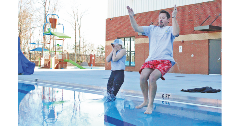 Assistant County Manager Rebecca Mincey and Commissioner Tucker Greene take a plunge into the icy cold waters of the Pinetree pool.
