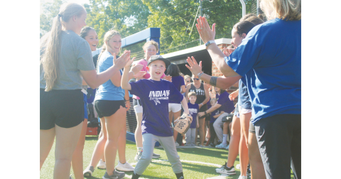 Local athlete Tommy England storms out of the dugout and onto the field ahead of the Heroes game.