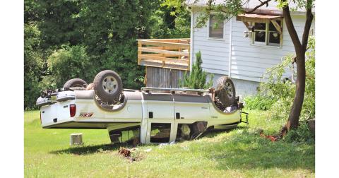 An out-of-control truck swerved off of Camp Wahsega Road last Thursday, drove into a tree and came to rest upside down. Postal carrier Mike Boyce, not pictured, was on the scene and was quick to help the accident victim who came away from the crash with minor injuries.
