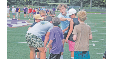 Micah Popko talks his team through a play during last week’s football camp.