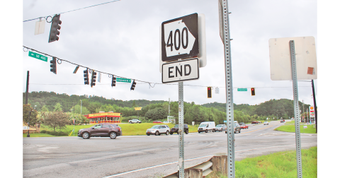 A road sign marking the northern terminus of Highway 400 stands on the future site of a dedicated right turn lane. The Georgia Department of Transportation is expected to break ground on the project later this year to ease congestion at the busy intersection.