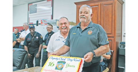 Deputy Chief Tony Kent celebrated 16 years with Lumpkin County Emergency Services during a retirement party Thursday afternoon at Fire Station #1. Below: Kent was gifted a commemorative axe by his peers.