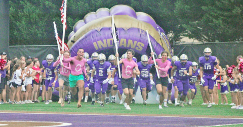 The Indians storm the field ahead of their showdown against Cherokee Bluff in the season opener.