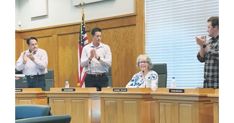 Mayor JoAnne Taylor receives an appreciative standing ovation from City Council members and attendees at last Monday's meeting.
