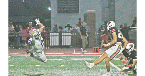 Wolf Harbin attempts to block a field goal against the Spartans.