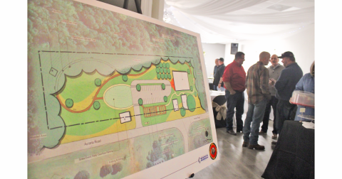 A concept plan depicts a restored Woody’s Store and Kate Woody Building facing Auraria Road, with the addition of a new 8,000 square foot museum and outdoor amphitheater behind them.