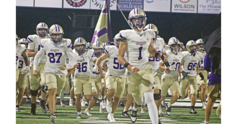Mac Powell leads the Lumpkin County team onto the field to face off against North Hall.