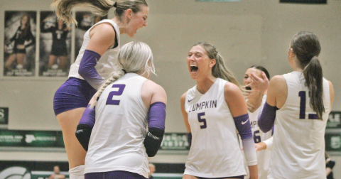 Layla Melius, Averie Simmons and Maddie Lee celebrate a Lumpkin score together.