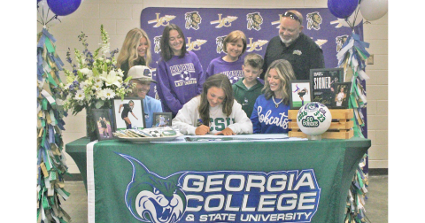 Rileigh Raftelis signs her commitment to attend Georgia College as a soccer player.