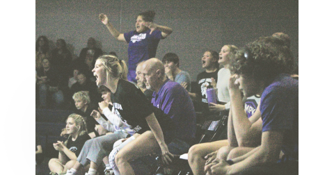 Gaby Luper and her Lumpkin teammates cheer on the squad from the sideline.