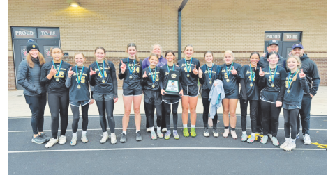 The 14U flag football team shows off their new State Championship trophy.