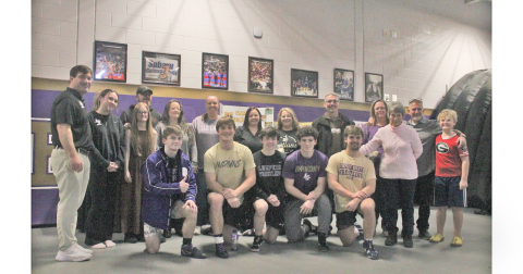 Lumpkin County wrestling seniors gather for a photo with their family and coaches following the match.