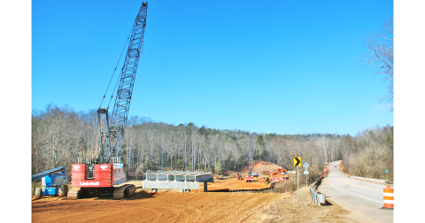 Heavy construction equipment can be seen next to the Chestatee River bridge on Highway 52 East. A section of GDOT’s replacement bridge has already been installed over the river.