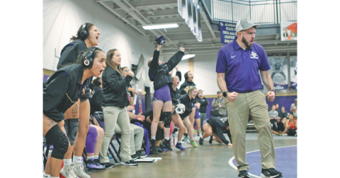 Coach Scott Degraff and the Lumpkin County Girls wrestling team celebrate a pin during one of their duals.