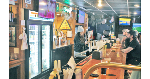 Bartender Victoria Woodall chats with customers as she pours a beer at Johnny B’s on Monday afternoon. The popular local restaurant and watering hole is set to close at the end of this month.