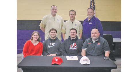 Jacob Baloga celebrates his college commitment alongside his family and coaches.