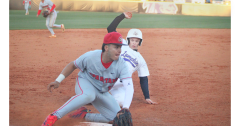 Logan Hamrick slides into third as a GAC defender blocks the bag.
