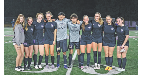 Soccer team seniors share a moment together on the 50-yard line during Lumpkin County Senior Night.