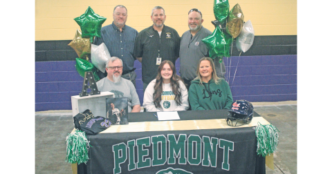 Ava Estes celebrates her college commitment with her coaches and family.