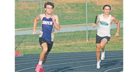 Jeb Jackson races his way to the hand-off in the boy’s relay race at White County.