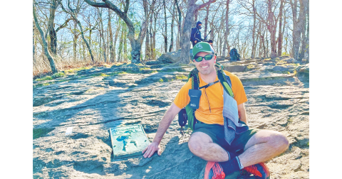 Kevin “Chop Chop” Remillard touches a plaque on Springer Mountain, the Southern terminus of the Appalachian Trail. Remillard completed a successful six month thru-hike of the AT in 2022 as part of a personal strategy to address anxiety and depression.