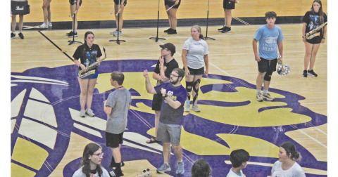Band Director Corey Jackson talks his students through the routine before the recent early preview of this year’s new band.